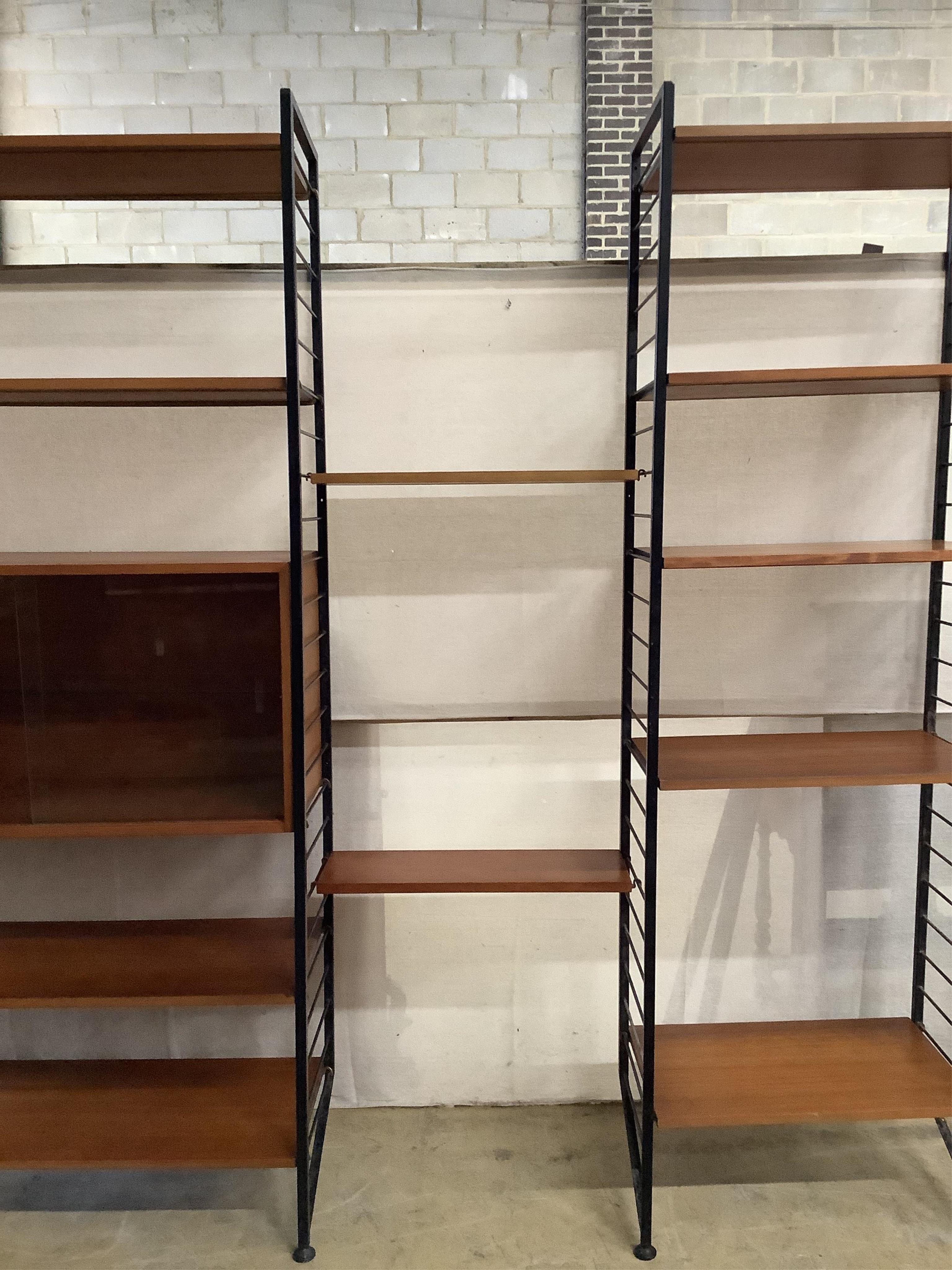 A mid century teak Ladderax shelving unit, width 215cm, depth 35cm, height 201cm. Condition - good